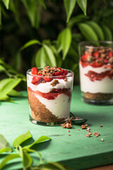 Breakfast layered parfait dessert with yogurt, sponge biscuit and fresh strawberry, white background copy space
