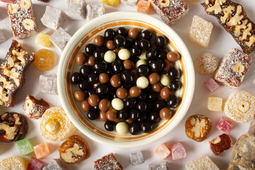Chocolate candies in the plate and Turkish delights around
