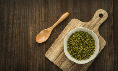 A plate with mung beans on a wooden table. template. background. 