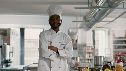 Portrait of male chef with arms crossed working in restaurant kitchen, cooking professional cuisine dish. Authentic cook making food preparations to do culinary gourmet meal, feeling confident.