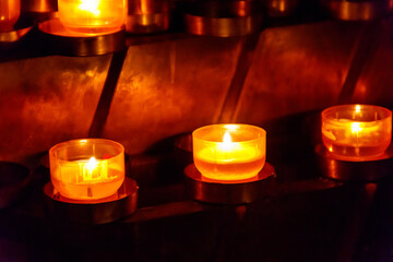 Many burning candles in a church