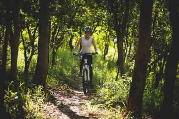 Naklejka premium Mountain biking in summer forest