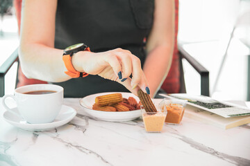 Churros with curry, olives and tomato paste on wooden table with Turkish tea