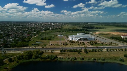Naklejka premium Lake on the outskirts of the city. A pond and multi-storey buildings are visible. Aerial photography.