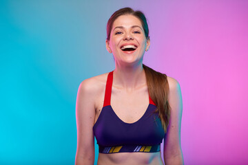 Fototapeta na wymiar Happy sporty woman in fitness sportswear with open mouth big smile with teeth. Female portrait isolated on neon multicolor background.