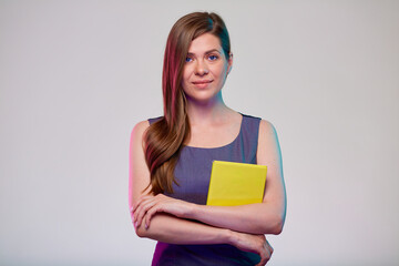 Teacher or smiling woman adult student with yellow book isolated portrait.