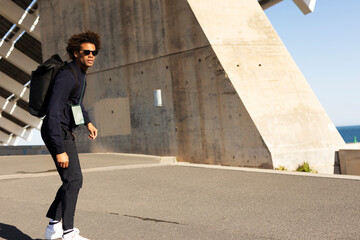 Handsome man with skateboard. Young smiling man having fun outdoors.