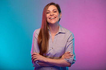 Smiling woman with arms crossed portrait in neon lights. Businesswoman isolated on neon...