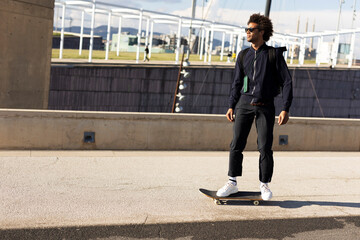 Handsome man with skateboard. Young smiling man having fun outdoors.