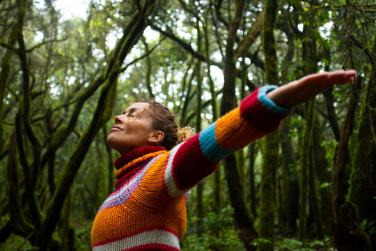 Freedom and happiness lifestyle and moment. Standing middle age young woman open arms and smile. Success life and nature feeling. Outdoors nature lover. Protect woods and sustainabiliy future