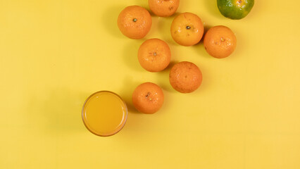 the composition of citrus fruits and glass of syrup made from fresh orange juice to drink