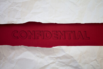 Confidential text with Torn, Crumpled White Paper on colored background.