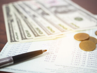 Closeup account statement banking with money and coin on table