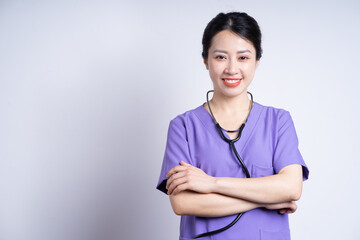 Portrait of young Asian nurse on white background