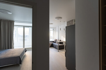 Modern minimalistic dark gray loft style studio apartment interior design. kitchen, sitting area, workplace
