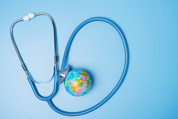 environment, ecology, planetary health, globe planet and stethoscope on blue background