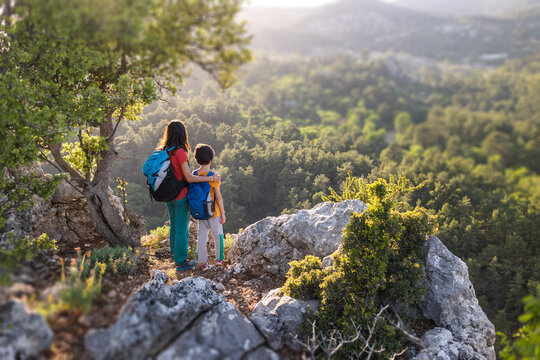 A woman is traveling with child, Boy with his mother looking at the mountains