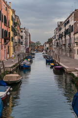 Typical street canal and colorful buildings in Venice, Italy