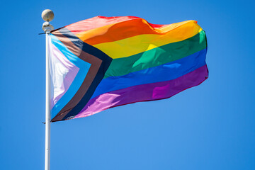 Rainbow flag (LGBT movement) waving in the wind. 
