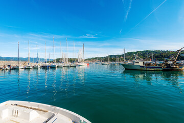 Port of the small Lerici town with many sailing boats and a fishing boat moored, tourist resort on...