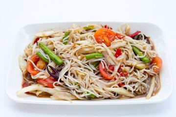 Spicy green papaya salad with vermicelli on white