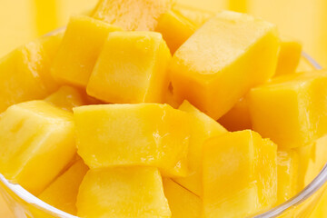 Yellow mango cube slices in glass bowl