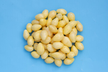 Boiled ginkgo nuts on blue background.
