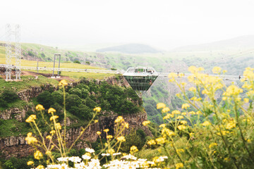 Diamond shape platform on glass bridge over scenic dashbashi valley in Georgia countryside. Famous modern bridge over valley in caucasus