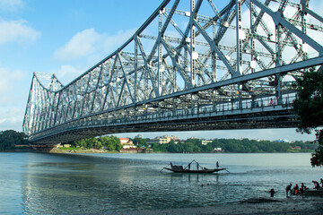 iconic Howrah bridge or Rabindra Setu  of Kolkata and boat in river Ganges 
