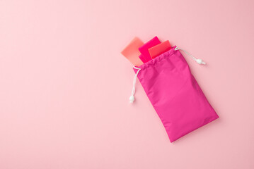 Sports concept. Top view photo of pink resistance bands in special bag on isolated pastel pink background with copyspace