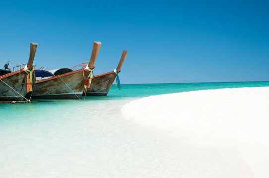 Shot of a boat docked on the shore on a beach in Phuket Thailand