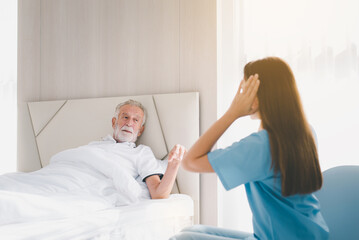 Senior men talking with caregiver in room,Nursing care home concept