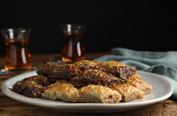 Delicious baklava with pistachios on wooden table
