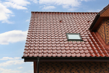 Fototapeta premium Beautiful house with red roof against blue sky
