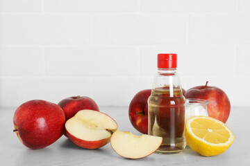 Apple vinegar, lemon and baking soda on white marble table. Eco friendly natural detergents