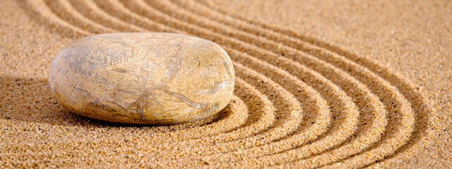 Fototapeta na wymiar Japanese ZEN garden with yin yang stones in textured sand