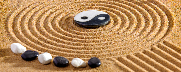 Fototapeta na wymiar Japanese ZEN garden with yin yang stones in textured sand