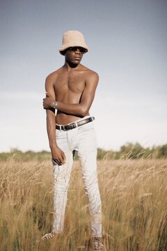 Young Black Man Standing In The Field In Zimbabwe