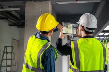 Engineer, architect and construction supervisor Use tablet to record information while inspecting...