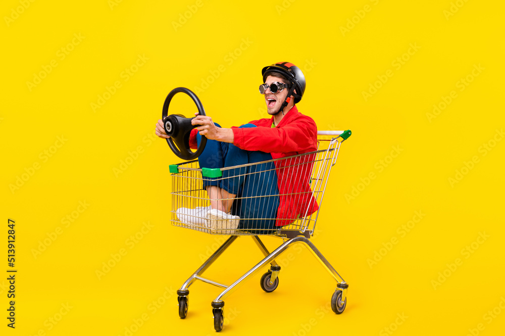 Poster full length body size view of attractive cheerful guy inside cart hold steering wheel isolated on br