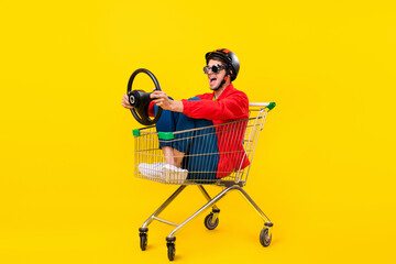Full length body size view of attractive cheerful guy inside cart hold steering wheel isolated on...