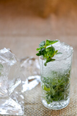 alcoholic mojito cocktail with ice and mint