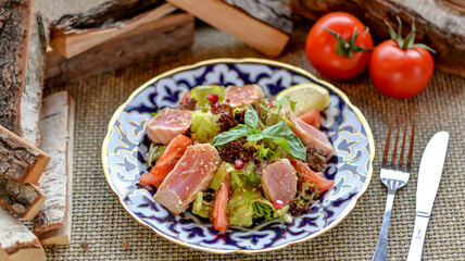 fresh salad with tuna on a patterned plate