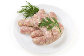 Raw chicken sausages with dill on dish on white background