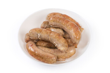 Baked chicken sausages in bowl on a white background
