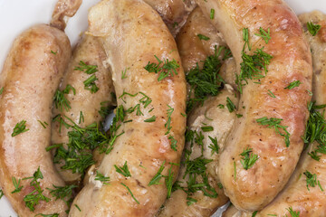 Top view of baked chicken sausages in bowl, close-up