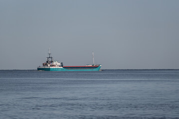 Fototapeta premium MARITIME TRANSPORT - A ship with a load is sailing on the sea