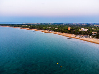 Fototapeta premium Sunrise in Lignano Sabbiadoro seen from above. From the sea to the lagoon, the city of holidays