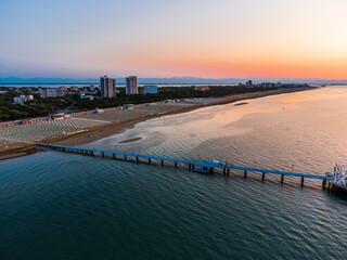 Obraz premium Sunrise in Lignano Sabbiadoro seen from above. From the sea to the lagoon, the city of holidays