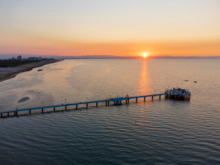Fototapeta premium Sunrise in Lignano Sabbiadoro seen from above. From the sea to the lagoon, the city of holidays